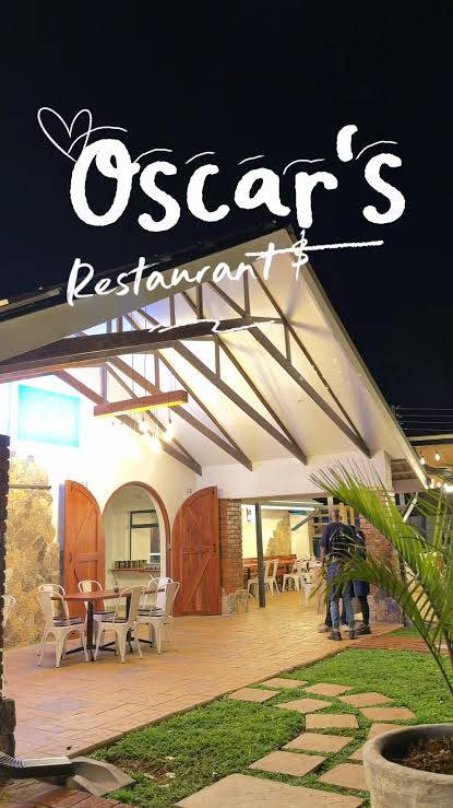 Oscar's Restaurant entrance and terrace at night